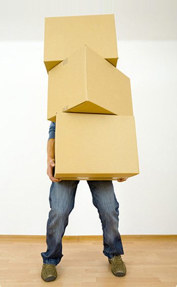 Man holding cardboards. Front view, whole body. Gray background